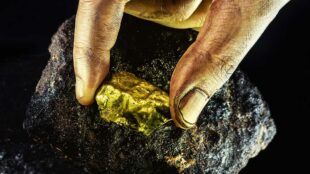 large-gold-stone-being-removed-from-mine-concept-of-mineral-extraction-and-gold-excavation-macro-photography