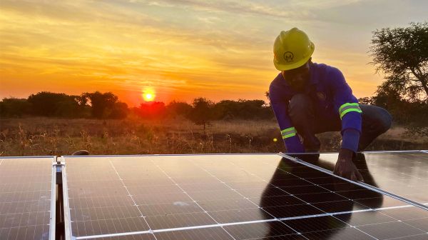 Renewable energy - a man installing solar panels